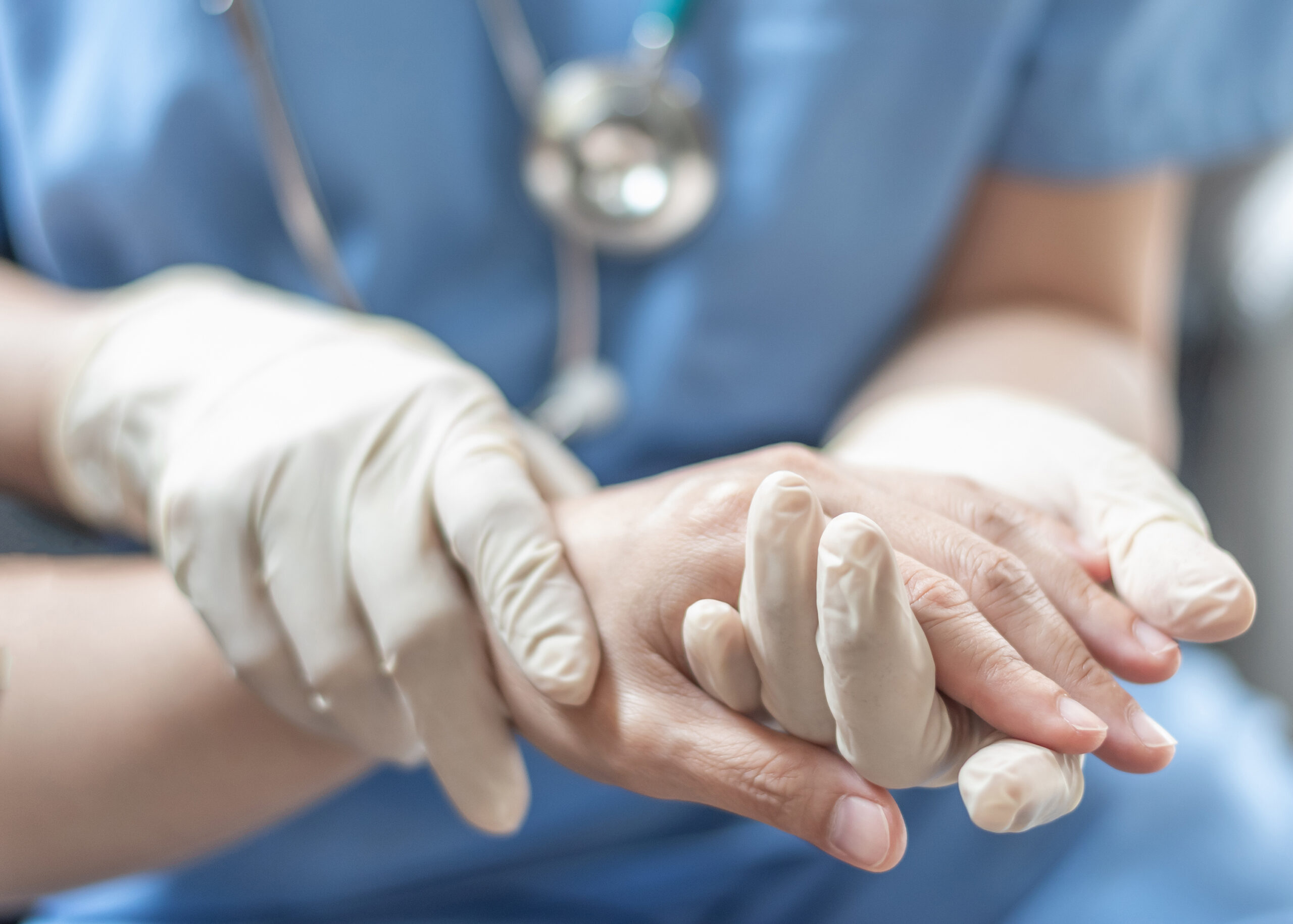 Nurse holding patient's hand